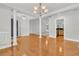 Open-concept living area with hardwood floors, columns, and access to the kitchen at 8618 Woodland Walk, North Charleston, SC 29420