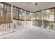 Screened porch with white railings, providing a serene outdoor living space at 8618 Woodland Walk, North Charleston, SC 29420