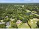 Stunning aerial view showcases the home’s location nestled among mature trees, golf course, and a tranquil pond at 914 Red Coat Run, Mount Pleasant, SC 29464