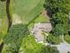Aerial view of a brick home surrounded by mature trees, lush landscaping, and a well-manicured lawn at 914 Red Coat Run, Mount Pleasant, SC 29464