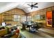 Spacious attic room with wood paneling, a large table, and a ceiling fan at 914 Red Coat Run, Mount Pleasant, SC 29464