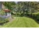 Expansive backyard featuring lush green grass, mature trees, and a lovely patio for outdoor enjoyment at 914 Red Coat Run, Mount Pleasant, SC 29464