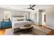 Well-lit bedroom featuring hardwood floors, ceiling fan, and a king size bed at 914 Red Coat Run, Mount Pleasant, SC 29464