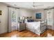 Bright bedroom with hardwood floors, large windows, and a comfortable bed with stylish pillows at 914 Red Coat Run, Mount Pleasant, SC 29464