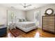 Cozy bedroom with hardwood floors, white walls, shuttered windows, and a comfortable bed at 914 Red Coat Run, Mount Pleasant, SC 29464