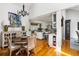 Dining area with open access to a bright kitchen and white wainscoting, creating an inviting space for Gathering and friends at 914 Red Coat Run, Mount Pleasant, SC 29464