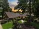 Charming brick home showcasing manicured landscaping, a well-lit walkway, and mature trees at 914 Red Coat Run, Mount Pleasant, SC 29464