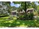 Beautiful backyard with mature trees, a screened porch, and a patio for outdoor enjoyment at 914 Red Coat Run, Mount Pleasant, SC 29464