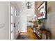 Elegant foyer with hardwood floors, console table, and textured wallpaper creating a warm and welcoming atmosphere at 914 Red Coat Run, Mount Pleasant, SC 29464