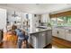 Bright kitchen with a large island, granite countertops, stainless steel appliances, and hardwood floors at 914 Red Coat Run, Mount Pleasant, SC 29464