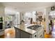 Open-concept kitchen with granite countertops, a gas cooktop island, and an adjacent dining area for seamless entertaining at 914 Red Coat Run, Mount Pleasant, SC 29464