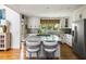 Stylish kitchen featuring a center island with seating, white cabinets, stainless steel appliances, and hardwood flooring at 914 Red Coat Run, Mount Pleasant, SC 29464