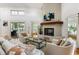 Cozy living room featuring a brick fireplace, comfortable seating, and access to an outdoor patio at 914 Red Coat Run, Mount Pleasant, SC 29464