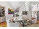 Bright and open living room with hardwood floors, white walls, and view to kitchen at 914 Red Coat Run, Mount Pleasant, SC 29464
