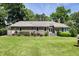Well-maintained brick home with a lush green lawn and mature landscaping in the backyard at 914 Red Coat Run, Mount Pleasant, SC 29464