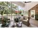 Relaxing screened porch with wicker furniture, ceiling fan, and view of the backyard at 914 Red Coat Run, Mount Pleasant, SC 29464