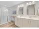 Modern bathroom featuring a glass-enclosed shower, double vanity with mirrors, and sleek fixtures for a spa-like experience at 9808 Wooden Pestle Way, Ladson, SC 29456