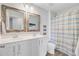 Charming bathroom featuring a double vanity with decorative mirrors and a toilet with a patterned shower curtain at 9808 Wooden Pestle Way, Ladson, SC 29456