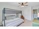 Bright bedroom with a bunk bed, cozy chair, and ceiling fan creating a functional and inviting space at 9808 Wooden Pestle Way, Ladson, SC 29456