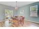 Dining room with a wooden table, bench seating, modern lighting and lots of natural light at 9808 Wooden Pestle Way, Ladson, SC 29456