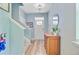 Bright entryway with a wooden accent table, leading to staircase with a small chandelier at 9808 Wooden Pestle Way, Ladson, SC 29456