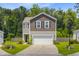 Charming two-story home featuring a neat lawn, a two-car garage, and lovely curb appeal at 9808 Wooden Pestle Way, Ladson, SC 29456