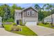 Beautiful home with a two-car garage, manicured lawn, and attractive landscaping at 9808 Wooden Pestle Way, Ladson, SC 29456