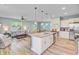 Open-concept kitchen with an island bar that overlooks the living room and dining area at 9808 Wooden Pestle Way, Ladson, SC 29456
