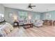 Bright and inviting living room with hardwood floors, comfortable seating, and ample natural light at 9808 Wooden Pestle Way, Ladson, SC 29456