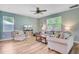 Spacious living room with comfortable seating, a ceiling fan, and a stylish entertainment center at 9808 Wooden Pestle Way, Ladson, SC 29456