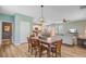 Open concept living space with a dining area, kitchen, and living room featuring hardwood flooring at 9808 Wooden Pestle Way, Ladson, SC 29456