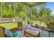 Inviting screened porch with comfortable seating and view of the backyard with playground at 9808 Wooden Pestle Way, Ladson, SC 29456