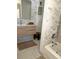 Spa-like bathroom features a modern vanity, marble tile, and a soaking tub for relaxation at 1014 E Cooper Ave, Folly Beach, SC 29439