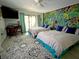 Bright bedroom with whimsical mural, fan, and sliding door leading to outdoor deck at 1014 E Cooper Ave, Folly Beach, SC 29439