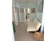 Bright hallway with white futon and pale blue walls; doorways lead to bathrooms and bedrooms at 1014 E Cooper Ave, Folly Beach, SC 29439