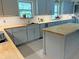 Bright kitchen with gray cabinetry, butcher block counters, and stainless steel appliances at 1014 E Cooper Ave, Folly Beach, SC 29439