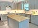 Modern kitchen featuring gray cabinets, butcher block countertops, an island, and stainless steel appliances at 1014 E Cooper Ave, Folly Beach, SC 29439