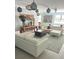 This stylish living room has white sofas, a decorative table, and eclectic art for a modern, inviting space at 1014 E Cooper Ave, Folly Beach, SC 29439