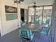 Cozy screened porch with dining table and chairs at 1014 E Cooper Ave, Folly Beach, SC 29439