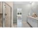 Bathroom with double sinks, tile flooring, and glass door shower with shampoo nook at 1035 Tea Time Dr, Summerville, SC 29485