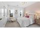 Bright bedroom with light pink wallpaper, light chair, and windows for natural light at 1035 Tea Time Dr, Summerville, SC 29485