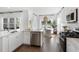 Bright and airy kitchen with stainless steel appliances, white cabinetry, and a seamless flow to the dining area at 1035 Tea Time Dr, Summerville, SC 29485