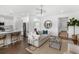Open-concept living space with stylish furniture, hardwood floors, and a seamless transition to the kitchen at 1035 Tea Time Dr, Summerville, SC 29485