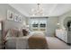 Comfortable main bedroom with view of lake and modern, unique chandelier lighting at 1035 Tea Time Dr, Summerville, SC 29485