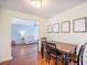 Cozy dining area with a wooden table, chairs, hardwood floors, and an adjacent living room at 105 Lovette Ct, Goose Creek, SC 29445