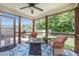 Inviting screened porch with comfortable seating, overhead lighting, and view of the landscaped backyard at 105 Lovette Ct, Goose Creek, SC 29445