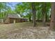 Spacious backyard with mature trees, an exterior view of the house, and a lush lawn at 105 Spring St, Summerville, SC 29485