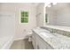 Well-lit bathroom with granite countertops, a shower-tub, and a tiled floor at 105 Spring St, Summerville, SC 29485