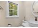 Well-lit bathroom with vessel sink, a stylish mirror, and a window providing natural light and a serene ambiance at 105 Spring St, Summerville, SC 29485