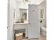 Bright bathroom features a vanity with gold hardware and lighting, ample storage, and a clean, welcoming atmosphere at 105 Spring St, Summerville, SC 29485